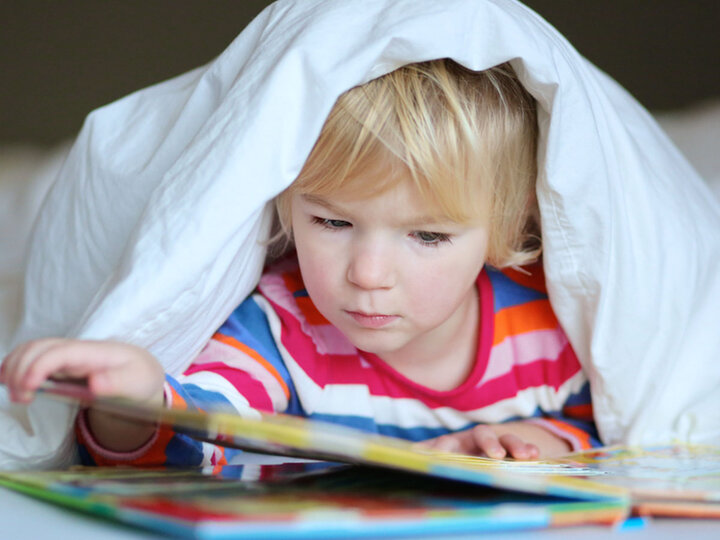 Child reading book.