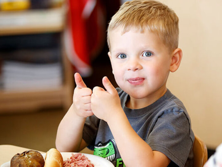 Boy showing thumbs up.